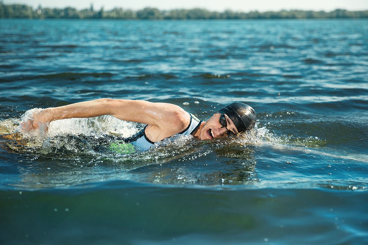 Professional triathlete swimming in river